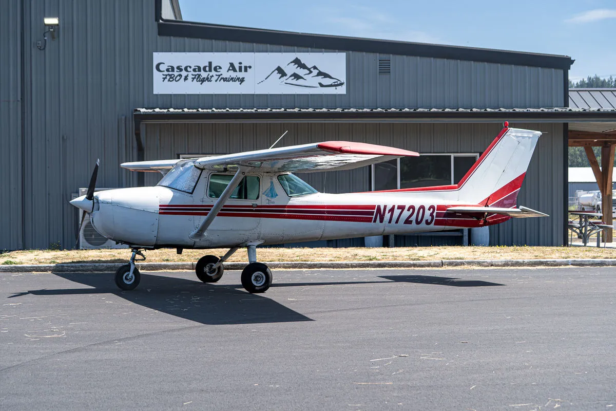 Cessna 150L N17203 parked in front of the Cascade Air hangar at KKLS.