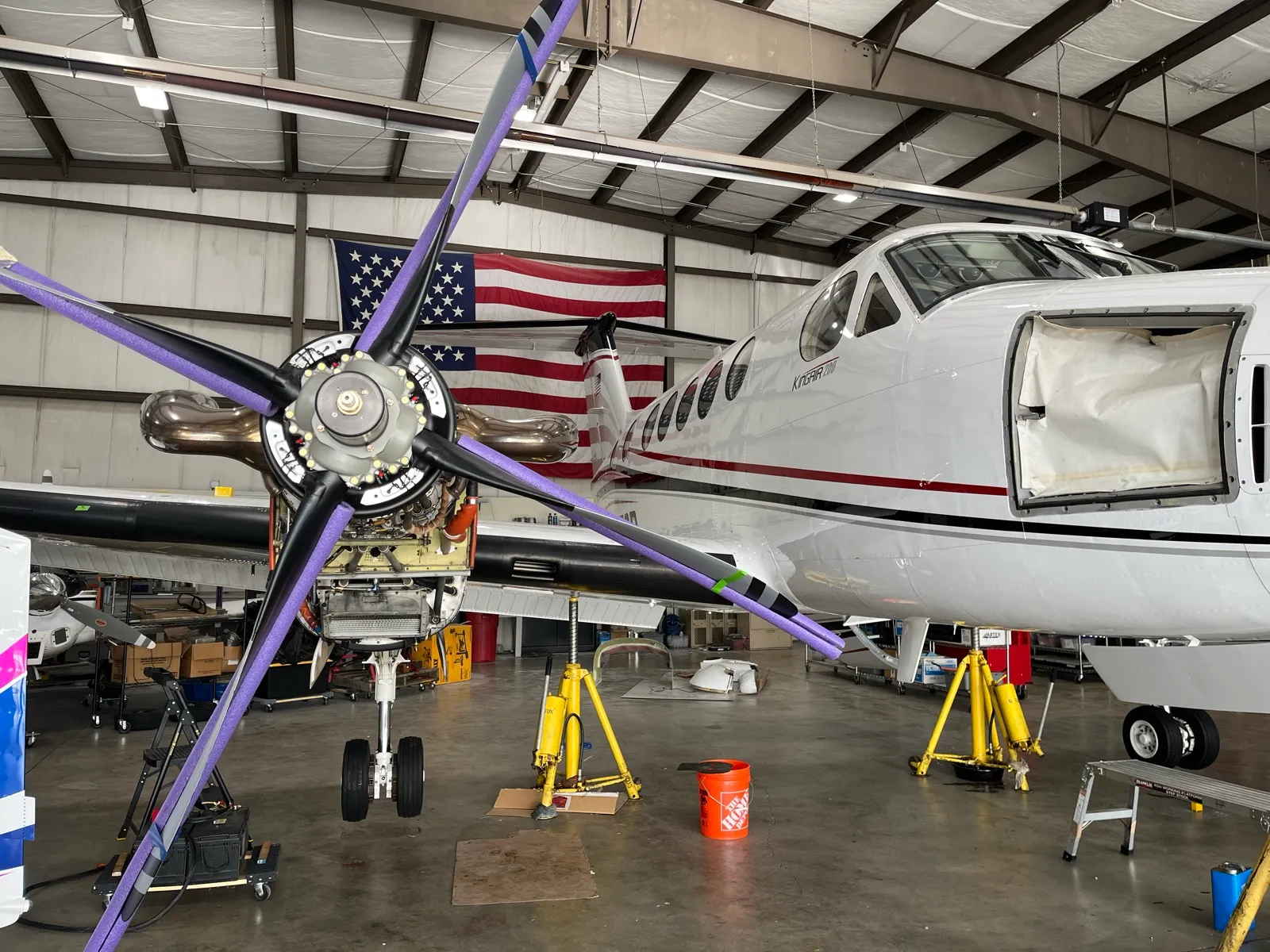 Aircraft maintenance work in progress inside the Cascade Air hangar at KKLS.